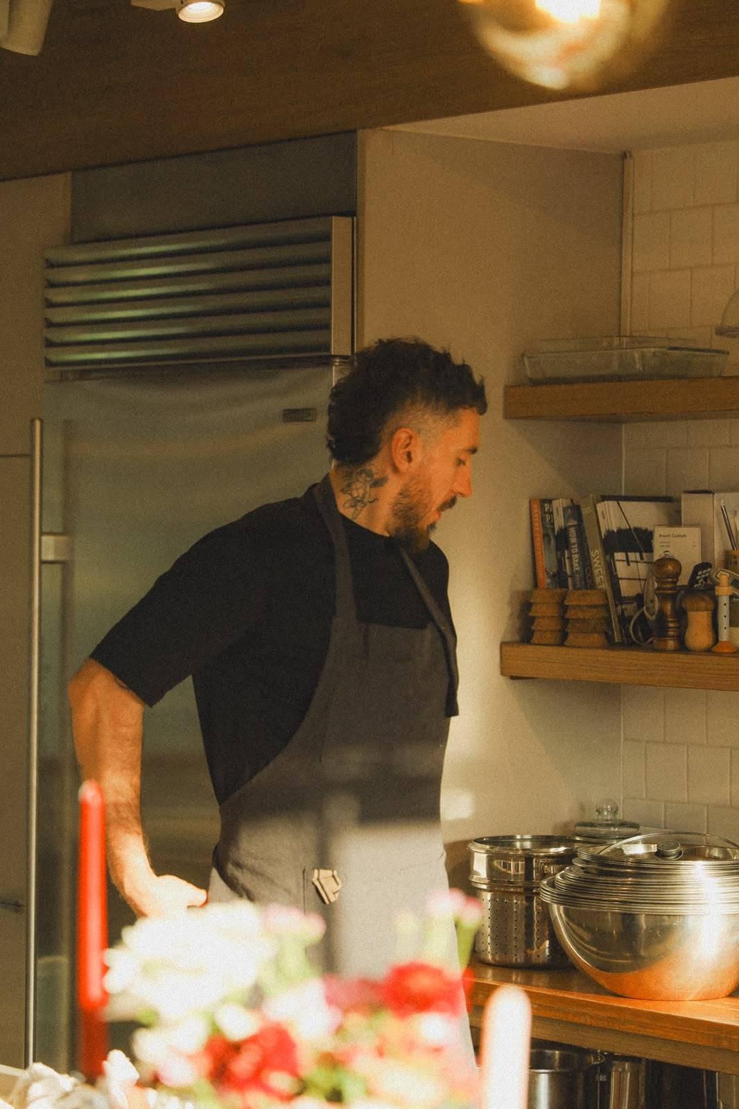 Chef Giuseppe Costanzo in a warm golden kitchen
